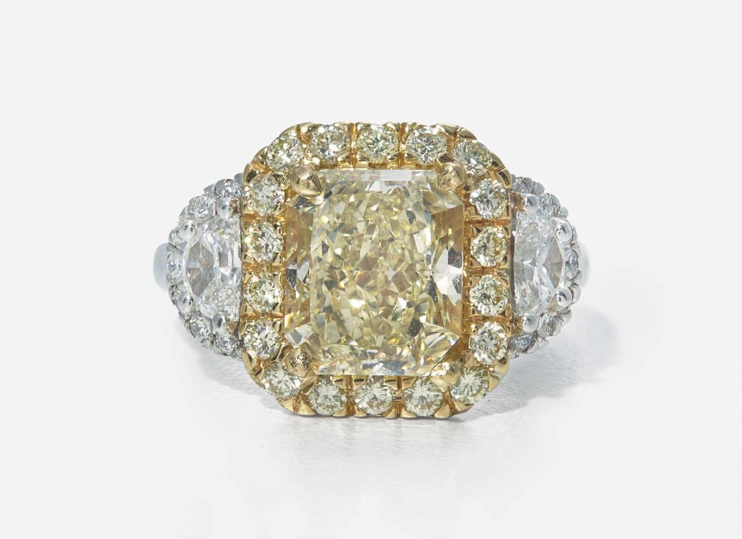 A Platinum, 18K Yellow Gold, Diamond, and 5.12 Carat Yellow Diamond Ring