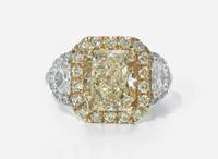 A Platinum, 18K Yellow Gold, Diamond, and 5.12 Carat Yellow Diamond Ring