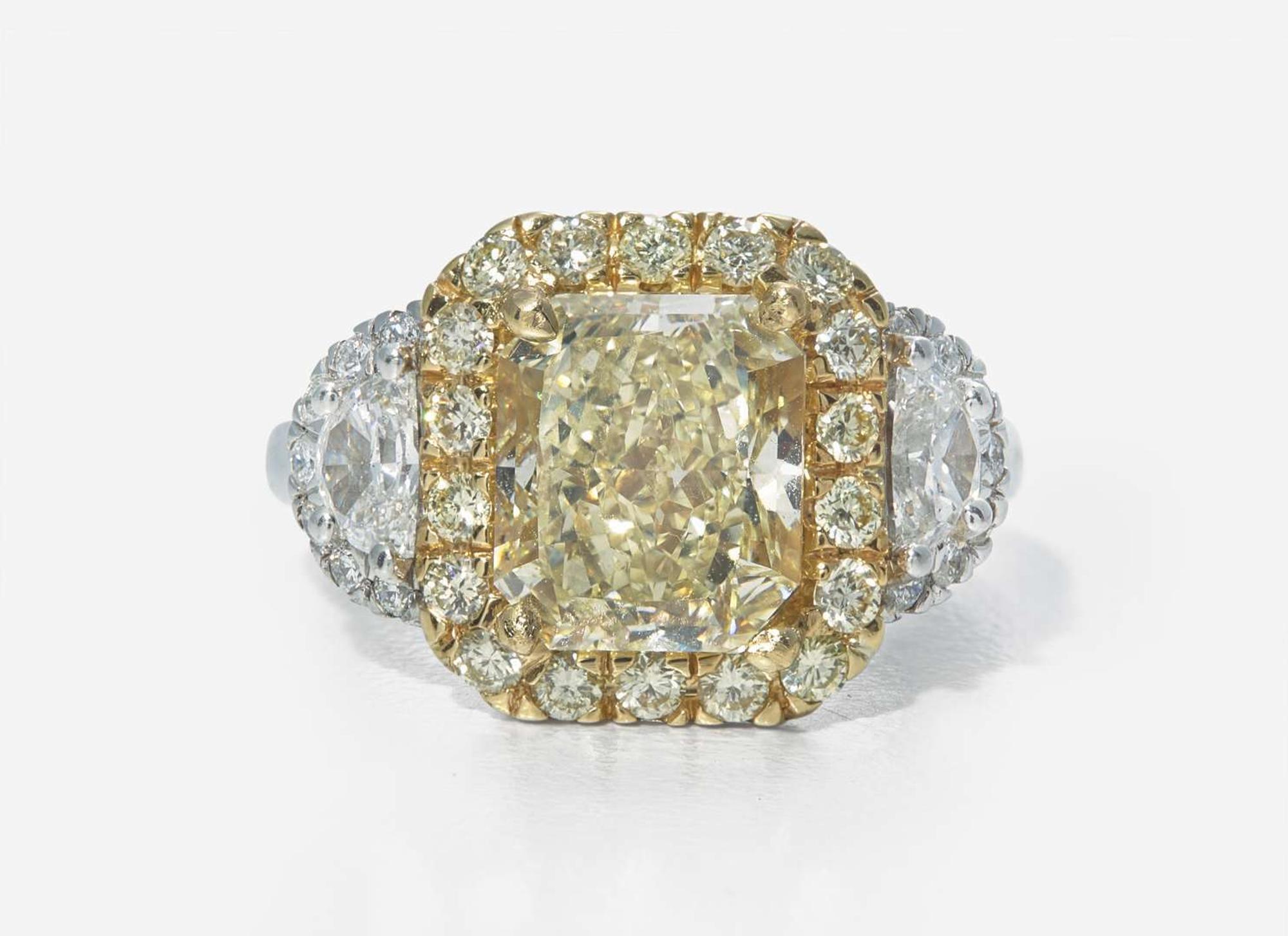 A Platinum, 18K Yellow Gold, Diamond, and 5.12 Carat Yellow Diamond Ring