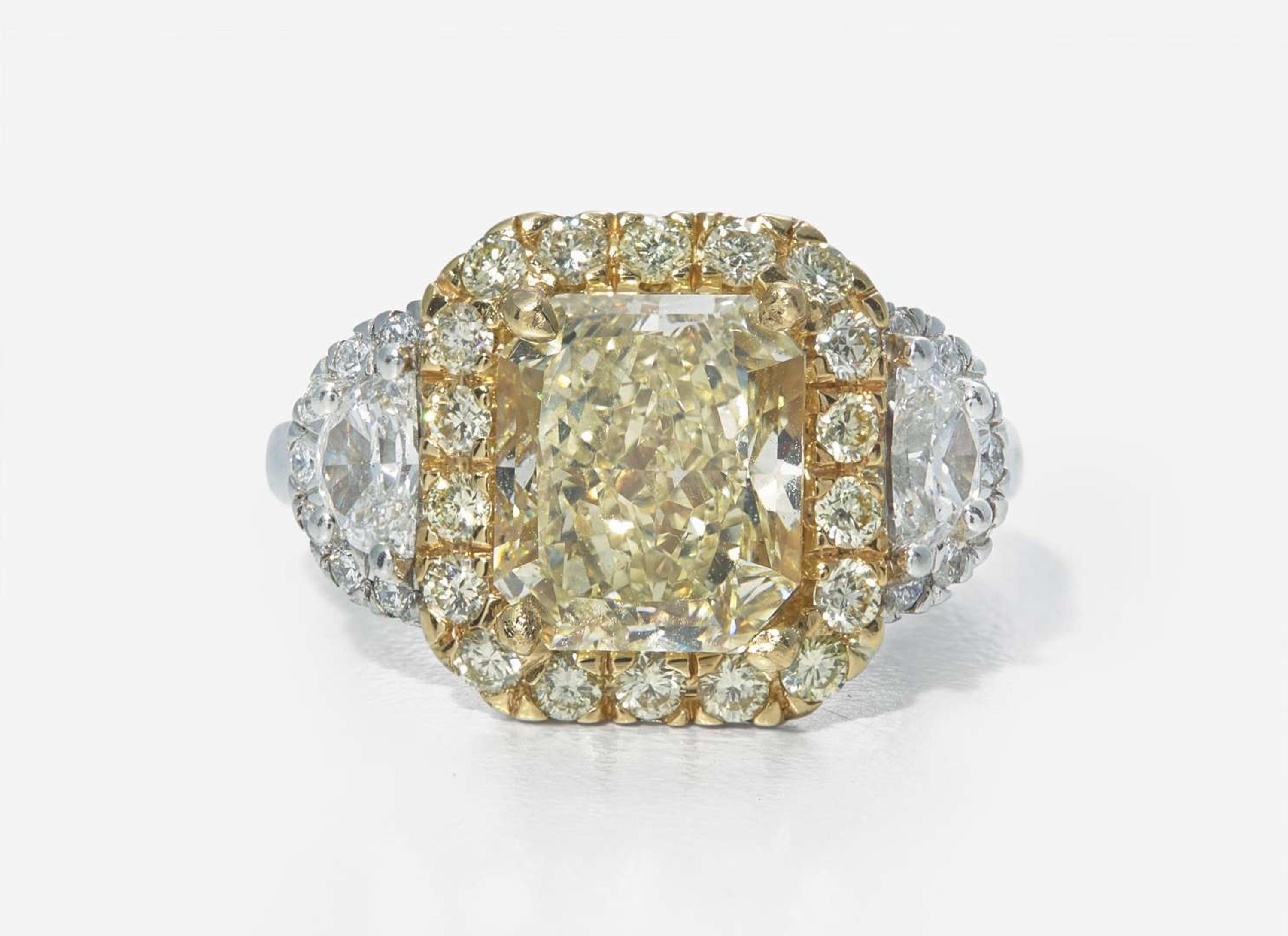 A Platinum, 18K Yellow Gold, Diamond, and 5.12 Carat Yellow Diamond Ring
