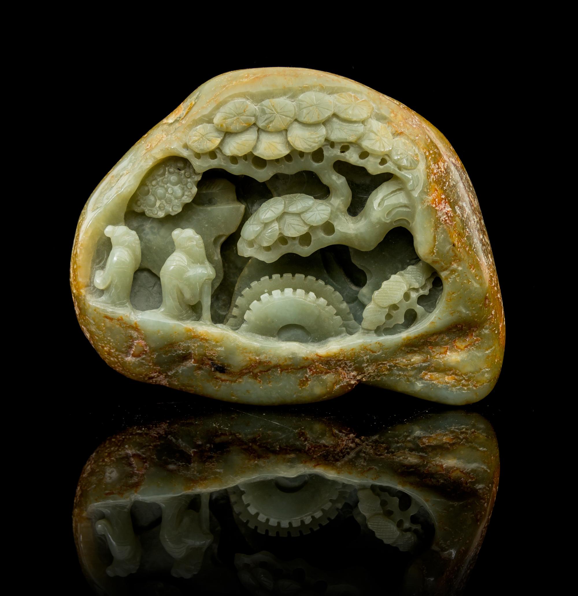 A Carved Celadon Jade Boulder Height 4 1/8 x width 5 1/2 inches.