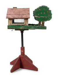A Carved and Painted Wood Directional Tree and House Bird Feeder