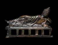 A Tibetan Bronze Figure of a Reclining Buddha