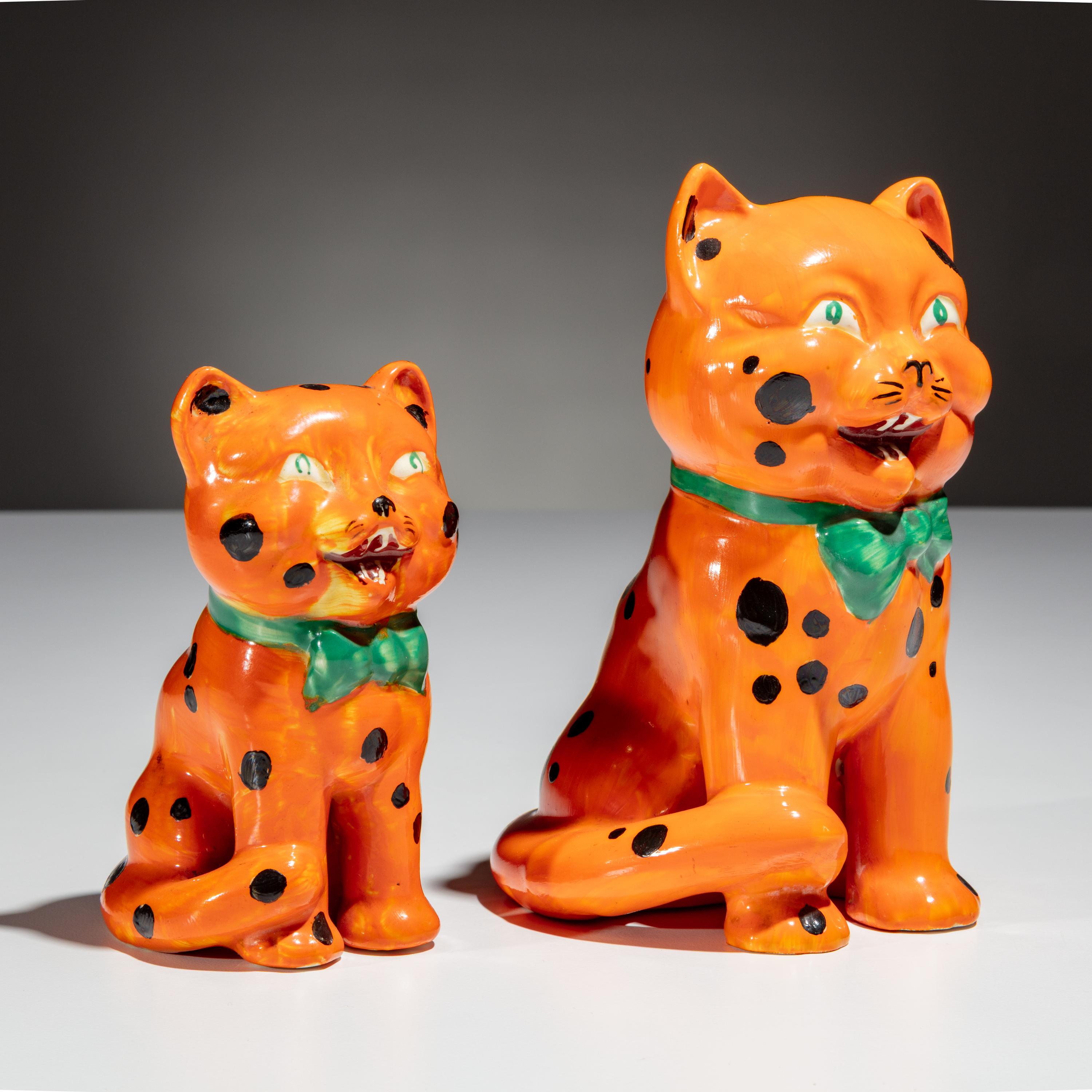 Clarice Cliff (English, 1899–1972) — Two Orange Laughing Cat Figures