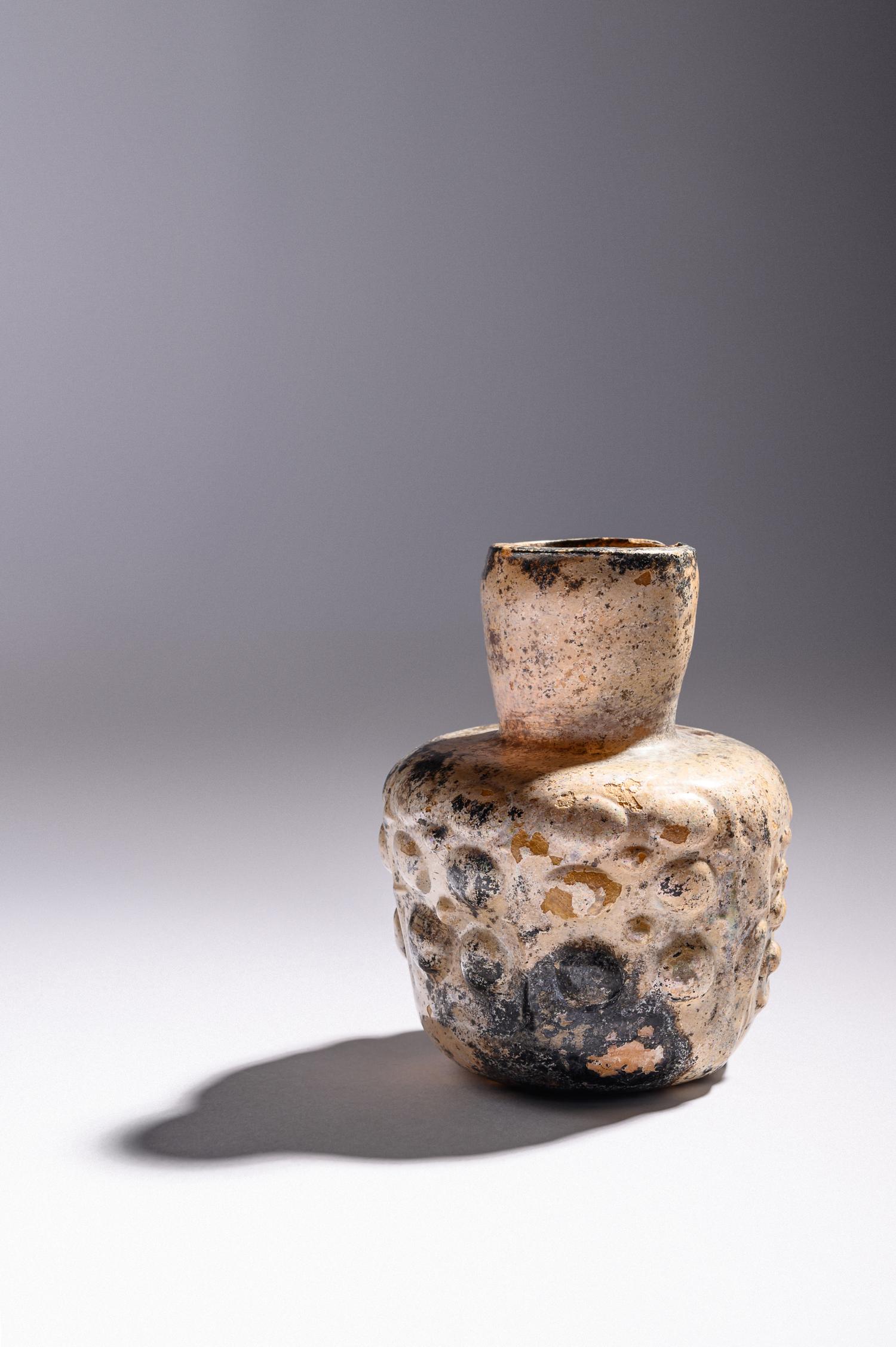 An Islamic Dark Yellow Glass Flask