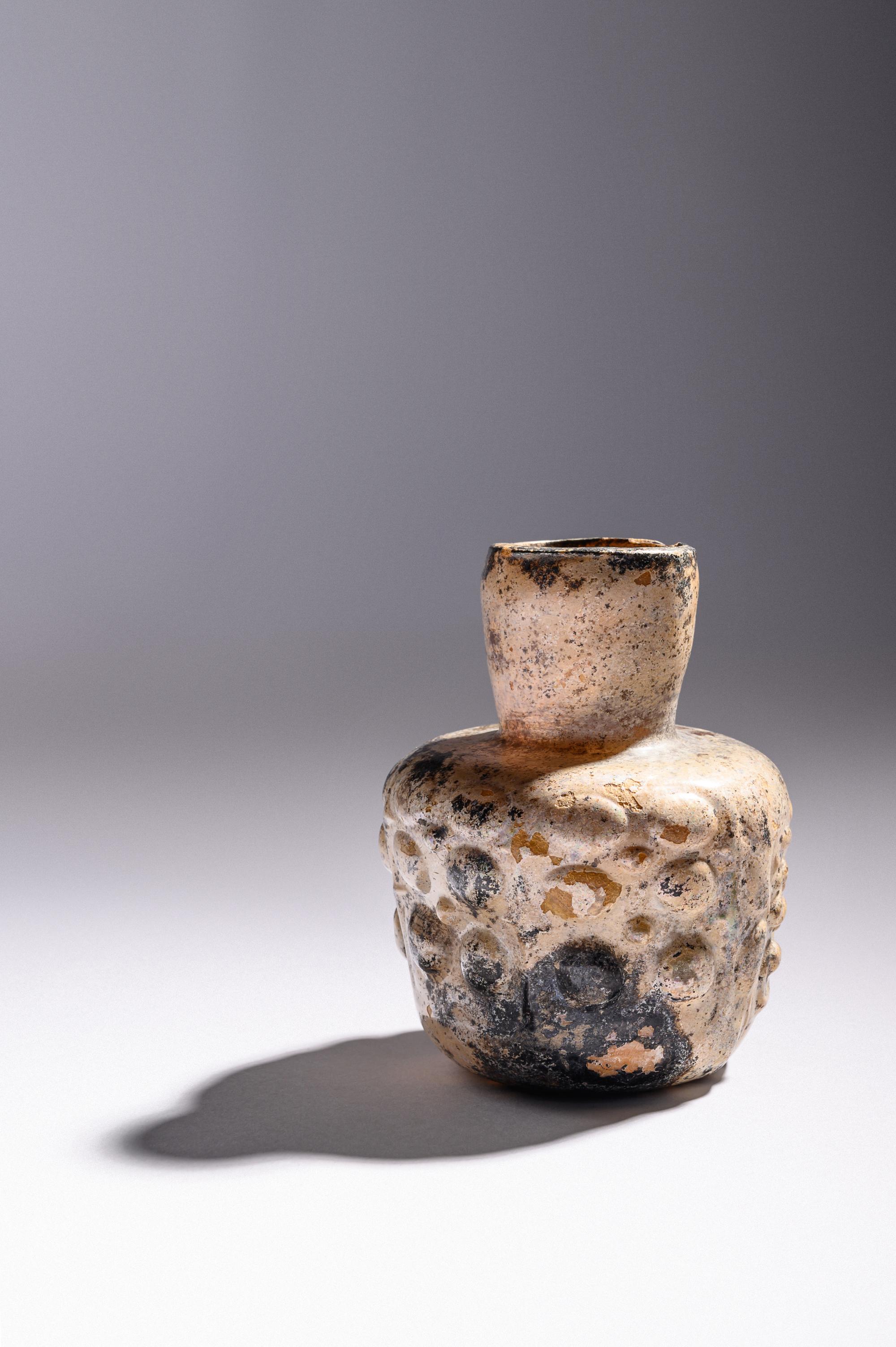 An Islamic Dark Yellow Glass Flask