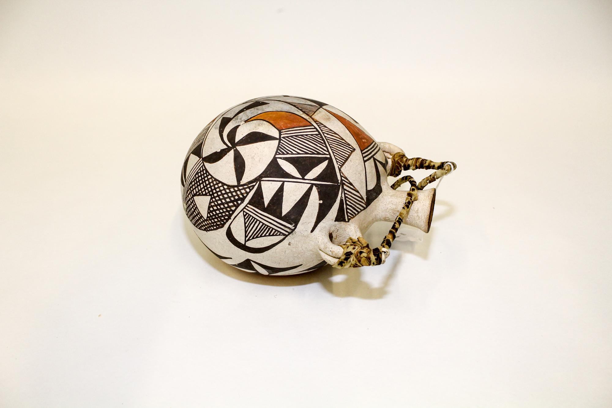 An Acoma Polychrome Canteen. Height 9 1/4 inches.