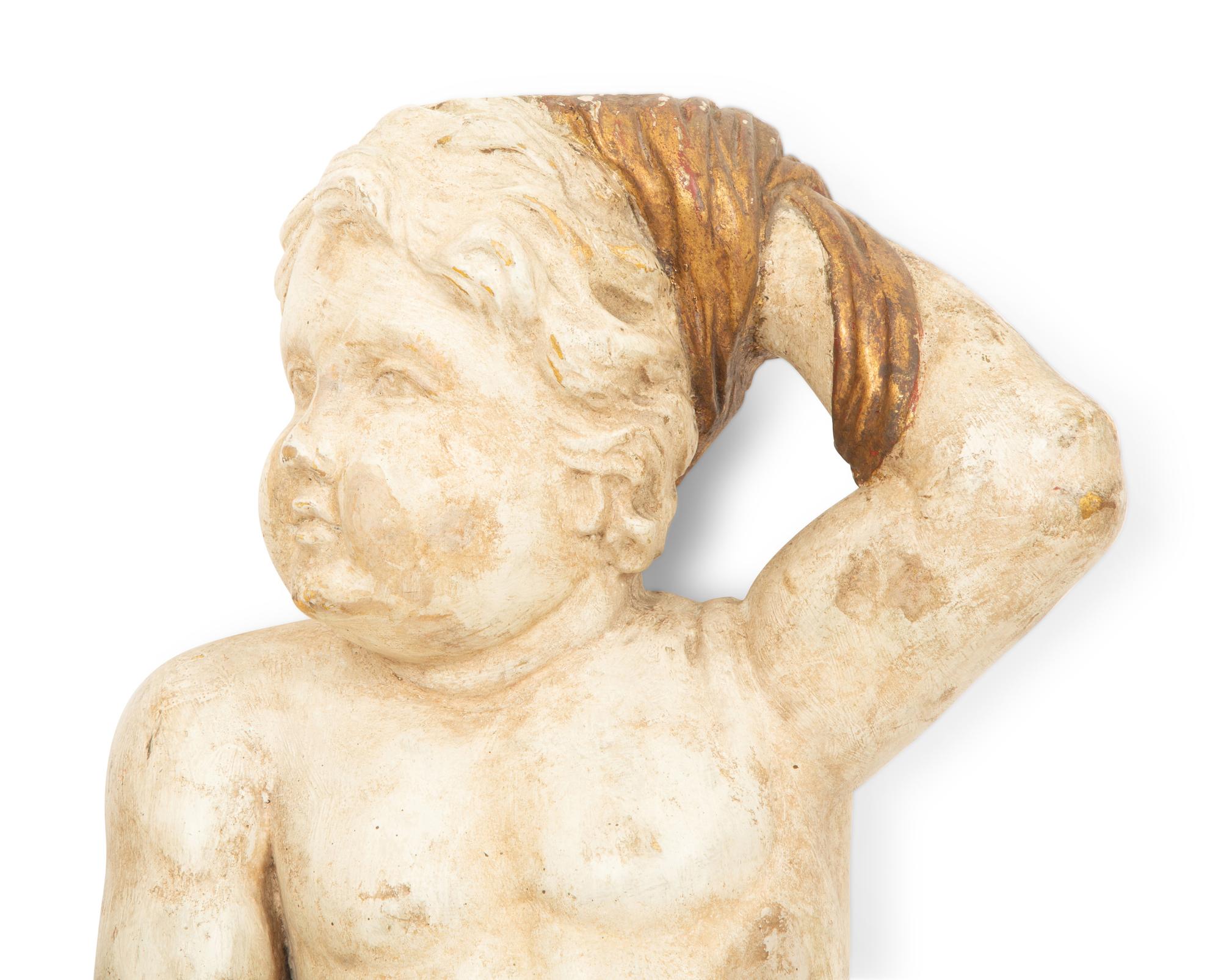 A Pair of Italian Carved, Painted and Parcel Gilt Putti