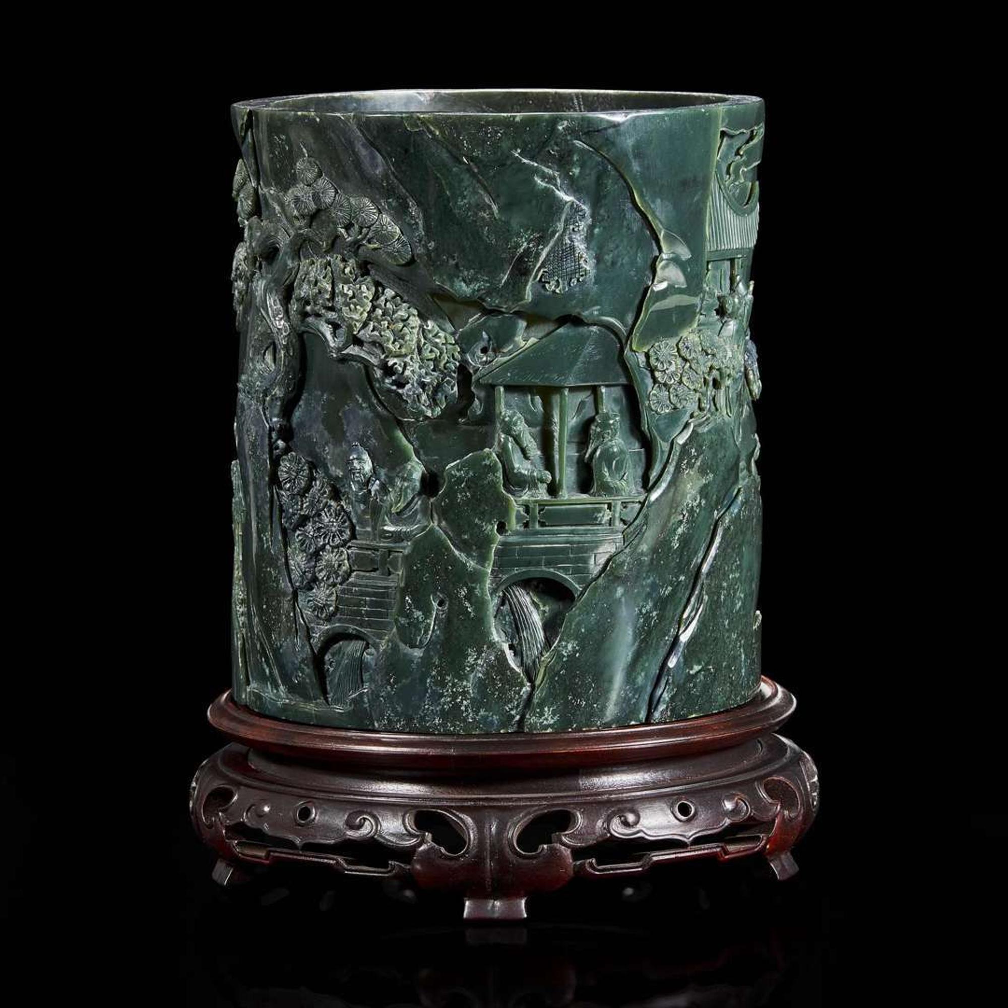 A Chinese carved dark green hardstone brushpot with marble-inlaid wood stand