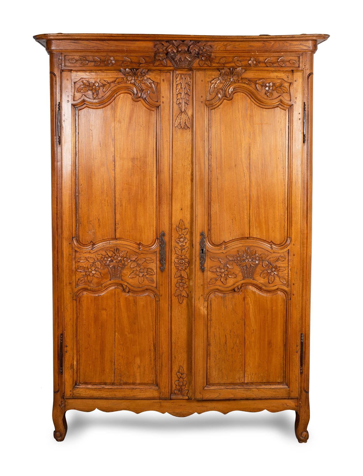 A Louis XV Provincial Carved Fruitwood Armoire — LATE 18TH/EARLY 19TH CENTURY