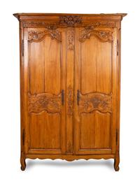 A Louis XV Provincial Carved Fruitwood Armoire — LATE 18TH/EARLY 19TH CENTURY