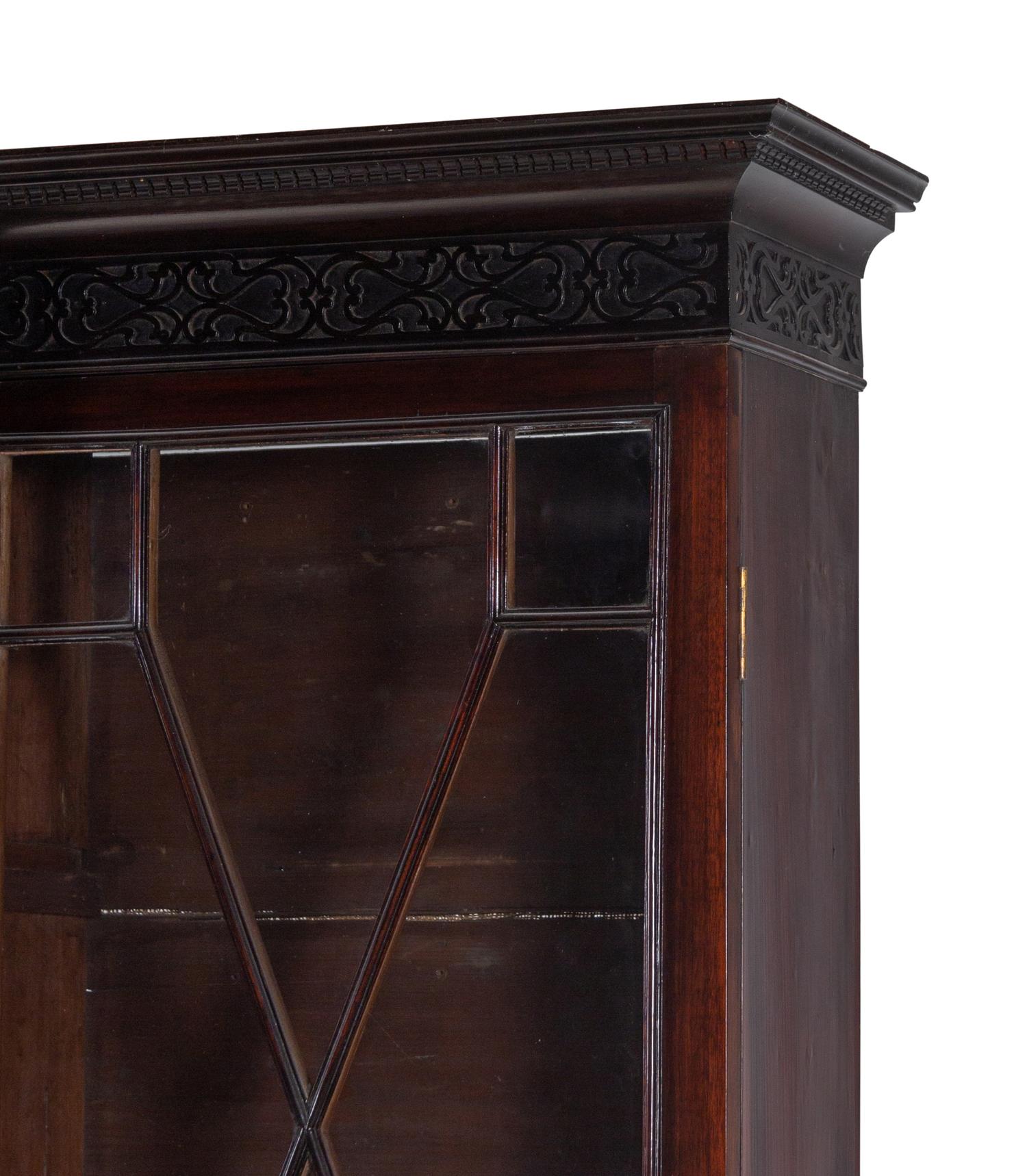 A Chinese Chippendale Pierce-Carved Mahogany Breakfront Bookcase on Stand