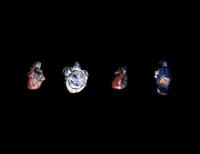 Four Phoenician Polychrome Glass Face Beads