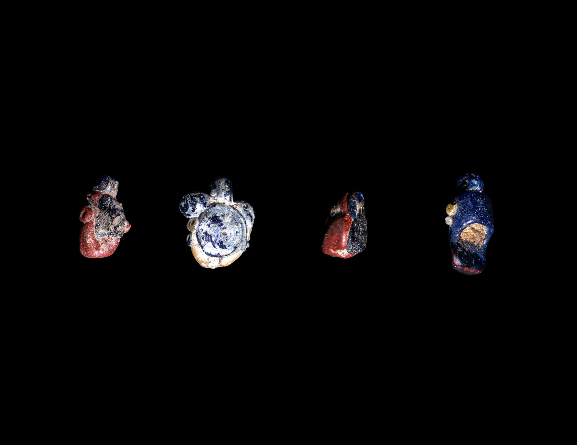 Four Phoenician Polychrome Glass Face Beads