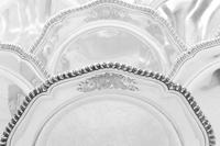 A Set of Twelve Irish George III Silver Dinner Plates, Robert Calderwood, Dublin, Circa 1762, each having an undulating gadrooned rim a