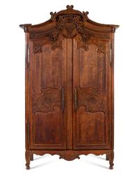 A French Provincial Carved Oak Armoire