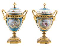 A Pair of Sevres Style Gilt Bronze Mounted Porcelain Urns Height 11 inches. — 19TH/20TH CENTURY