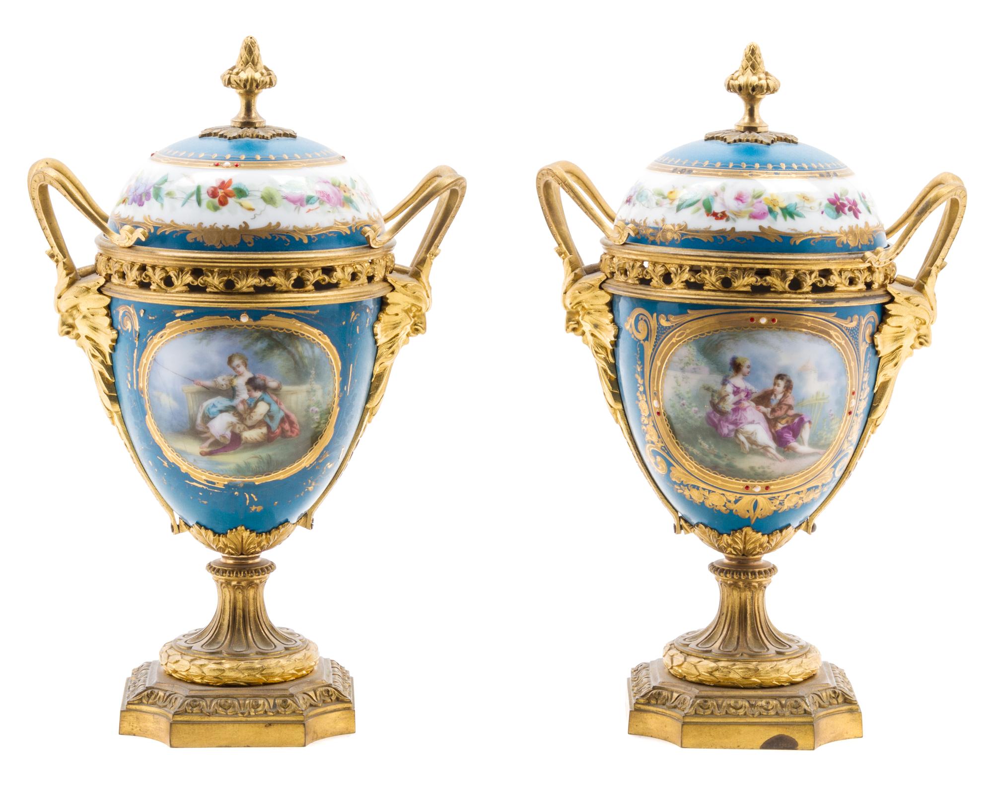 A Pair of Sevres Style Gilt Bronze Mounted Porcelain Urns Height 11 inches. — 19TH/20TH CENTURY