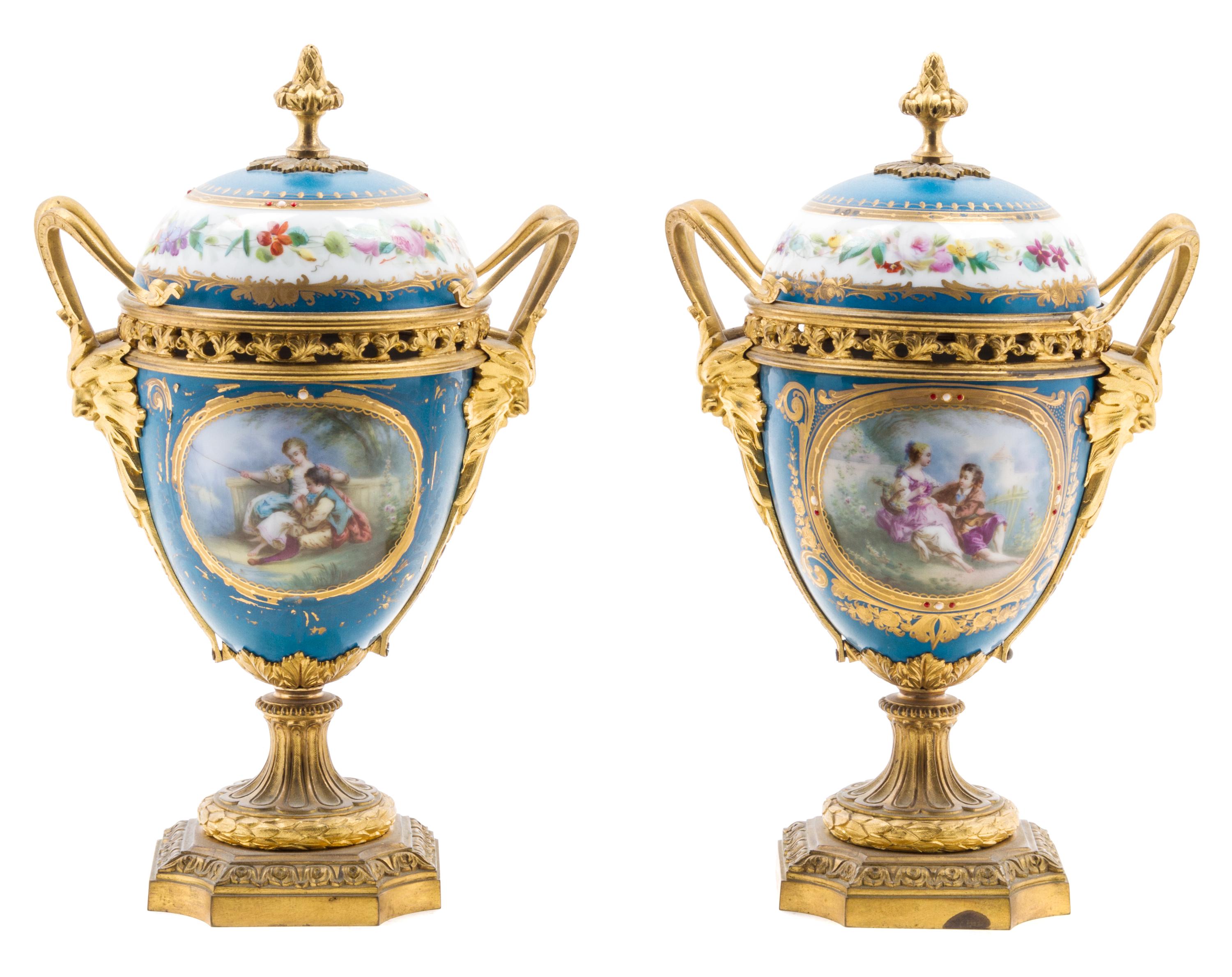 A Pair of Sevres Style Gilt Bronze Mounted Porcelain Urns Height 11 inches. — 19TH/20TH CENTURY