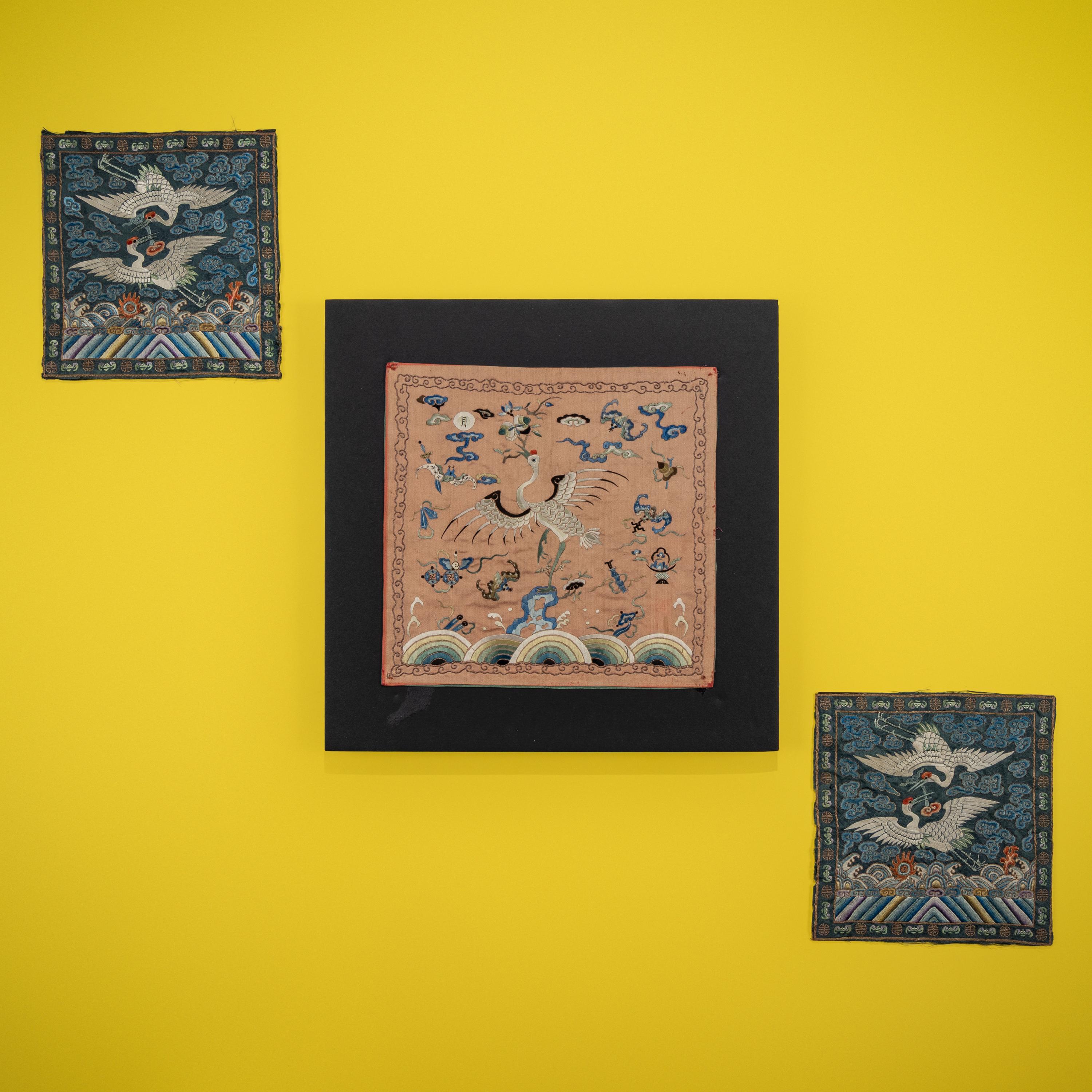 A Pair of Korean Embroidered Silk 'Double Crane' Rank Badges and a Vietnamese Salmon Pink Ground Embroidered Silk 'Crane' Rank Badge, Late 19th Century — 十九世紀晚期 朝鮮王朝文官鶴紋補子一對及越南鶴紋補子
