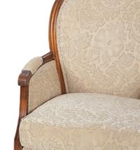 A Pair of Louis XVI Style Carved Walnut Bergères