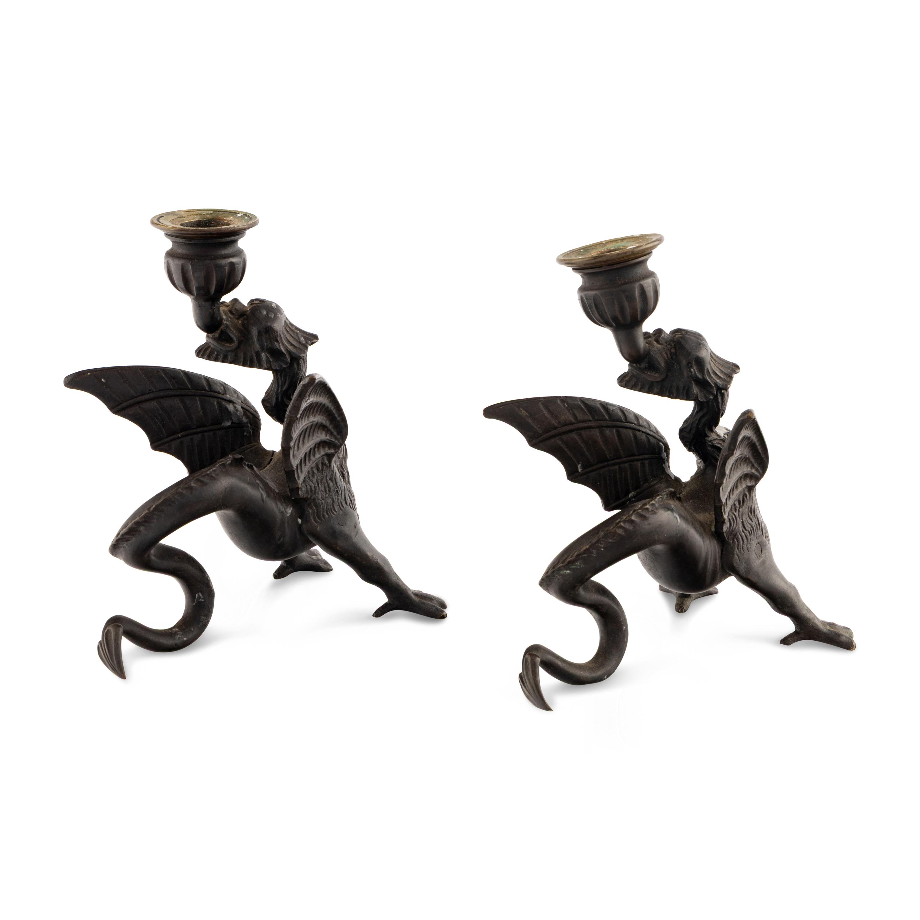 A Pair of Cast Metal Griffin Candlesticks