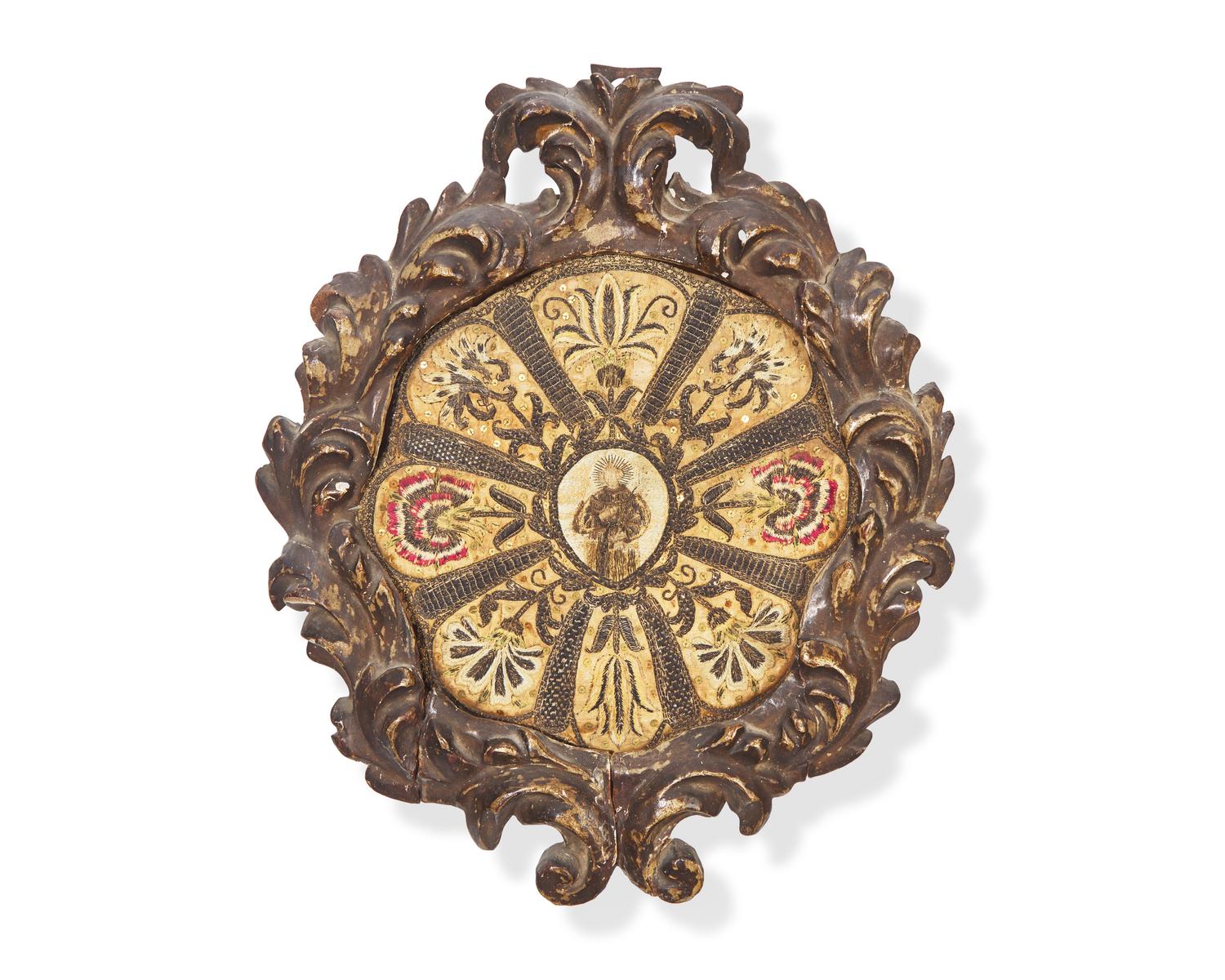 An Italian ecclesiastical embroidered silk roundel depicting a Saint, 18th century
