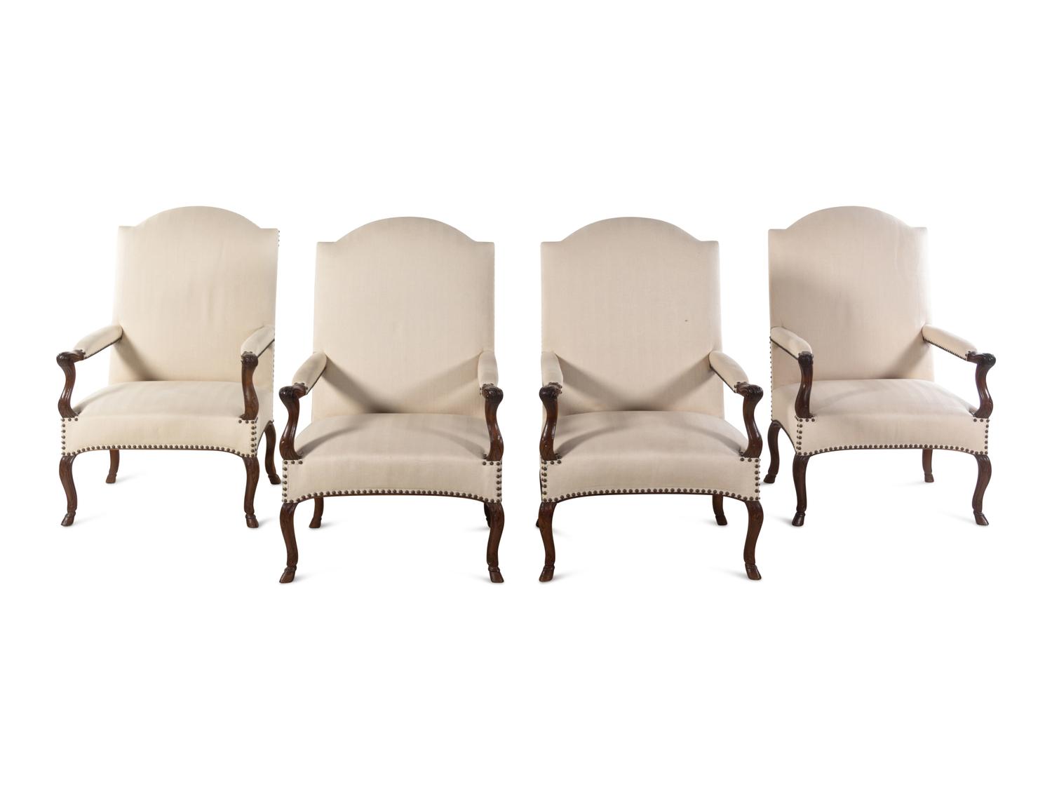 A Set of Four Régence Style Carved Walnut Library Chairs