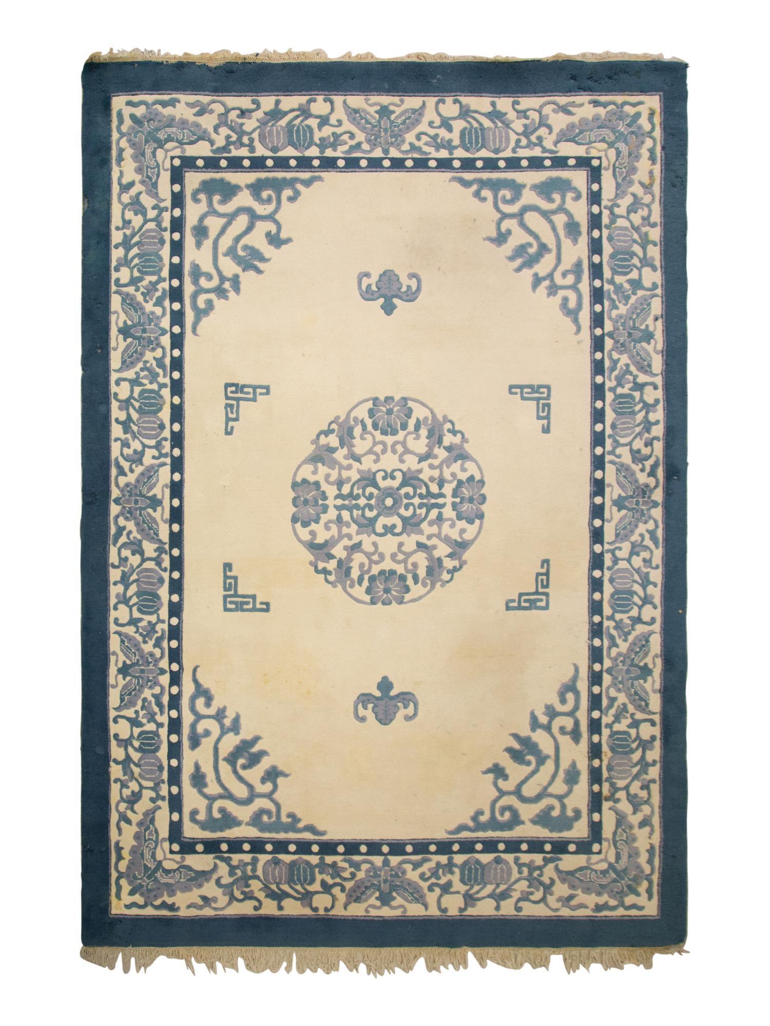 An Indian Blue and Ivory Chinese Style Wool Rug