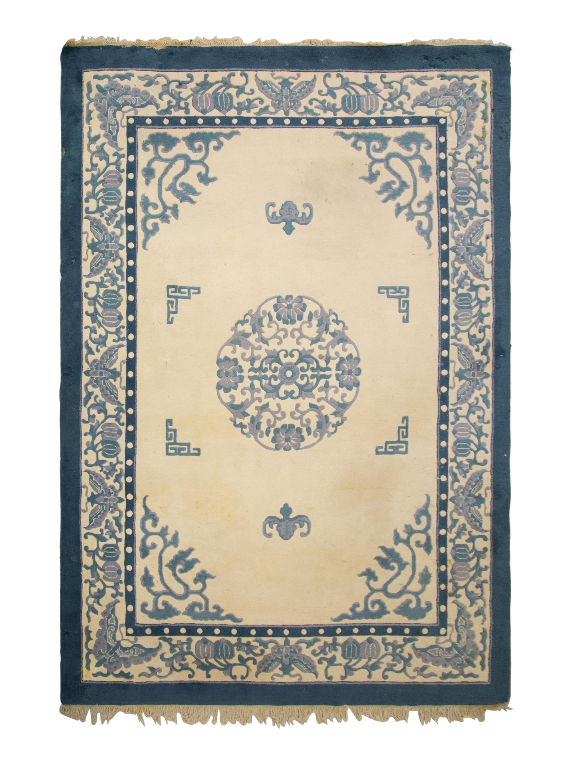 An Indian Blue and Ivory Chinese Style Wool Rug