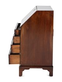 A Chippendale Figured and Shell-Carved Mahogany Slant Front Desk