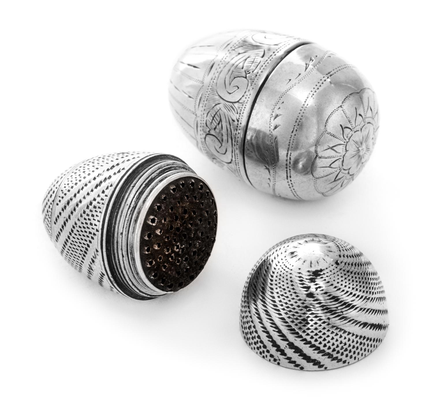Two Silver Nutmeg Graters, , each of ovoid form with engraved exteriors.