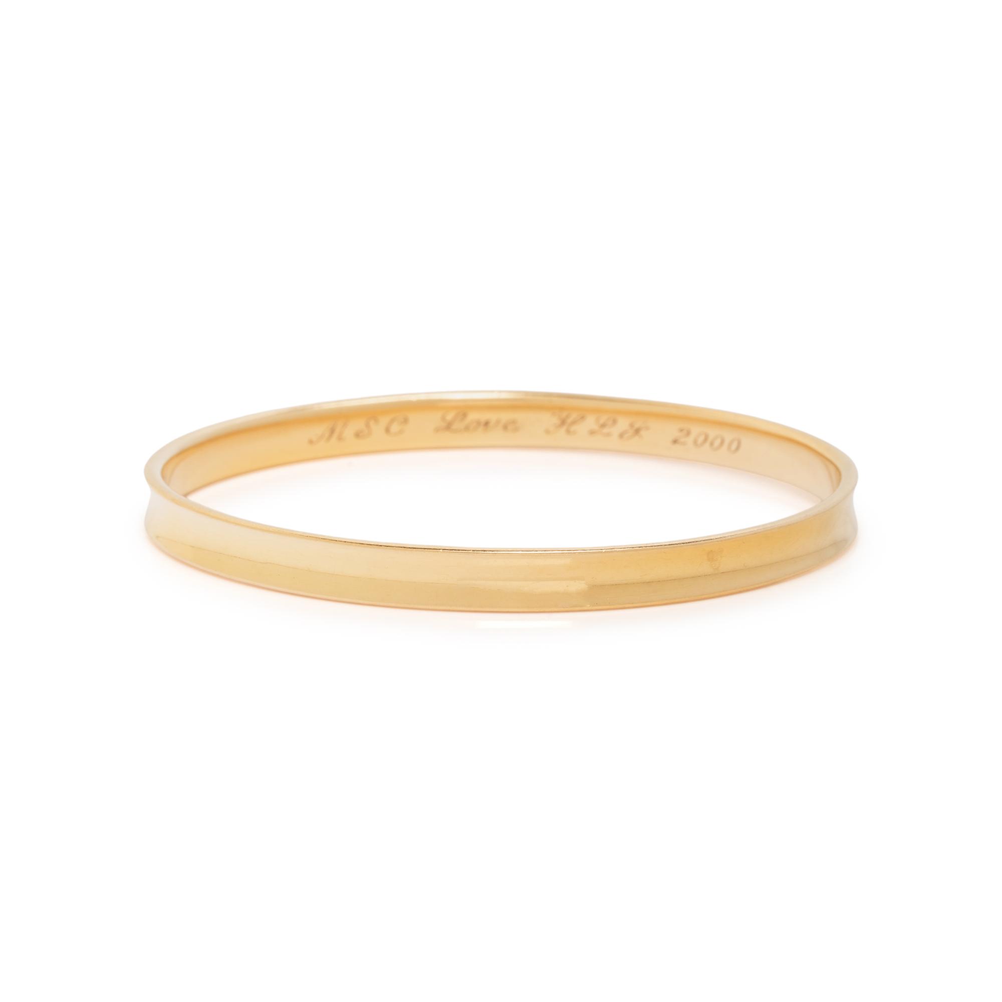 TIFFANY & CO., YELLOW GOLD ANNIVERSARY BANGLE BRACELET