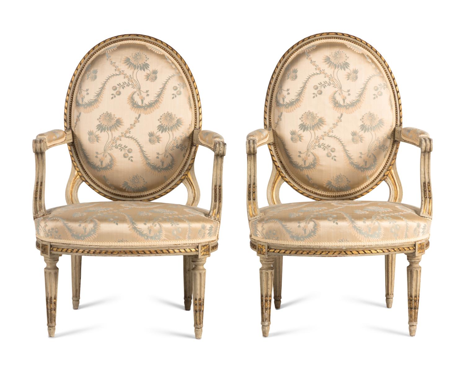 A Pair of Louis XVI Painted and Parcel Gilt Fauteuils