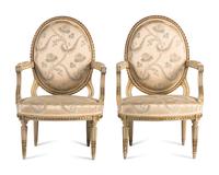 A Pair of Louis XVI Painted and Parcel Gilt Fauteuils