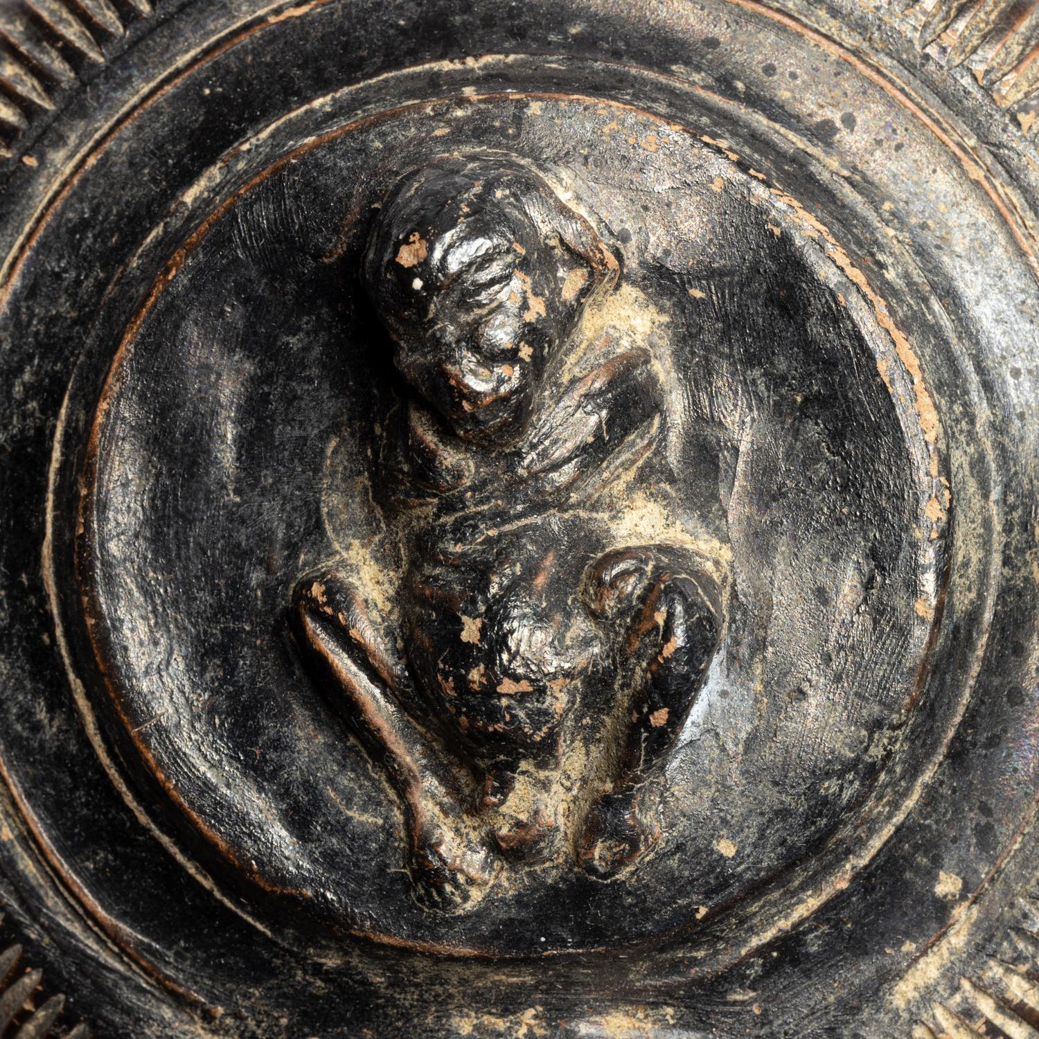 A Campanian Black-Glazed Guttus with a Grotesque