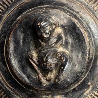 A Campanian Black-Glazed Guttus with a Grotesque