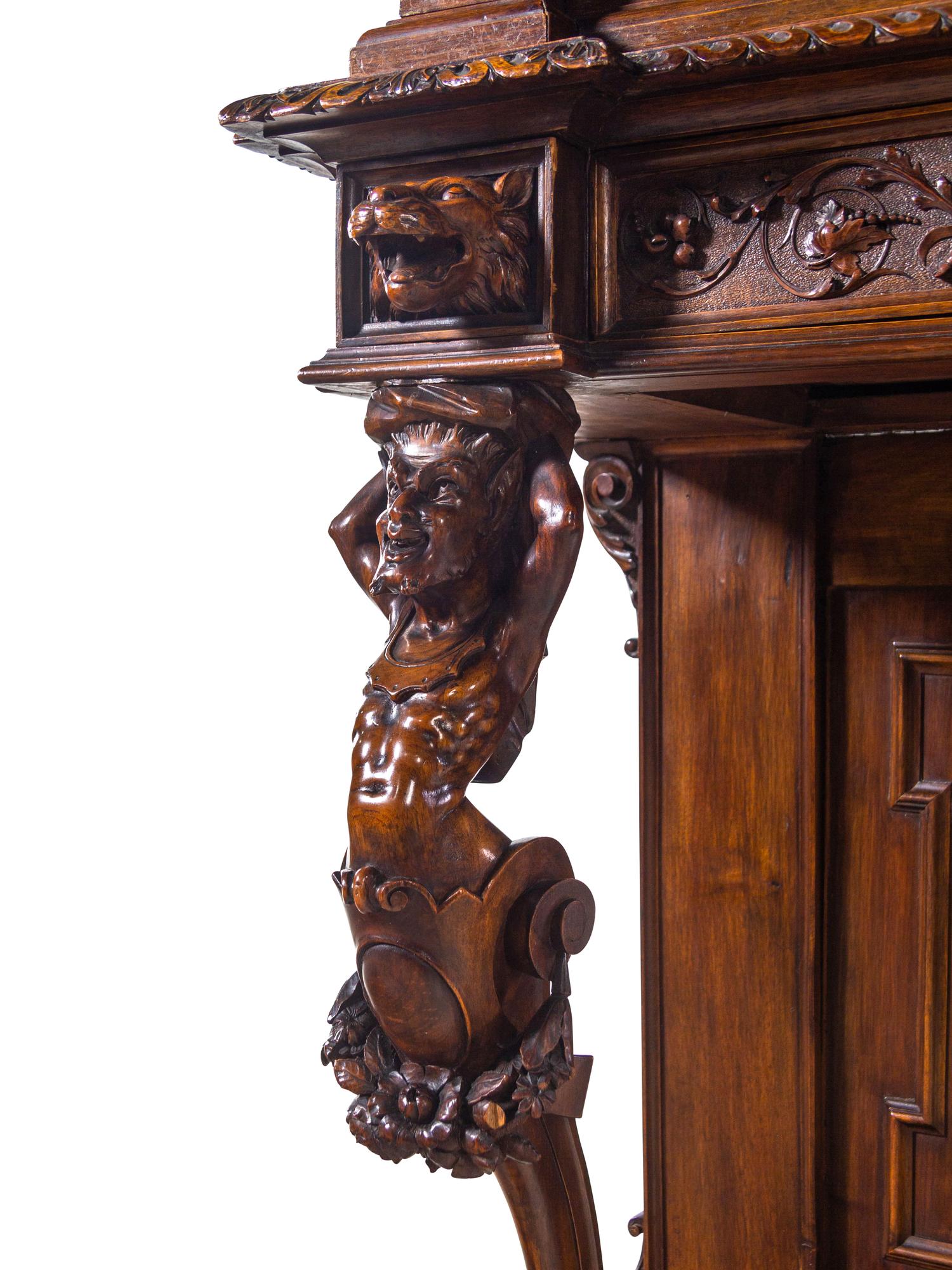 A Renaissance Revival Carved Walnut Cabinet on Stand