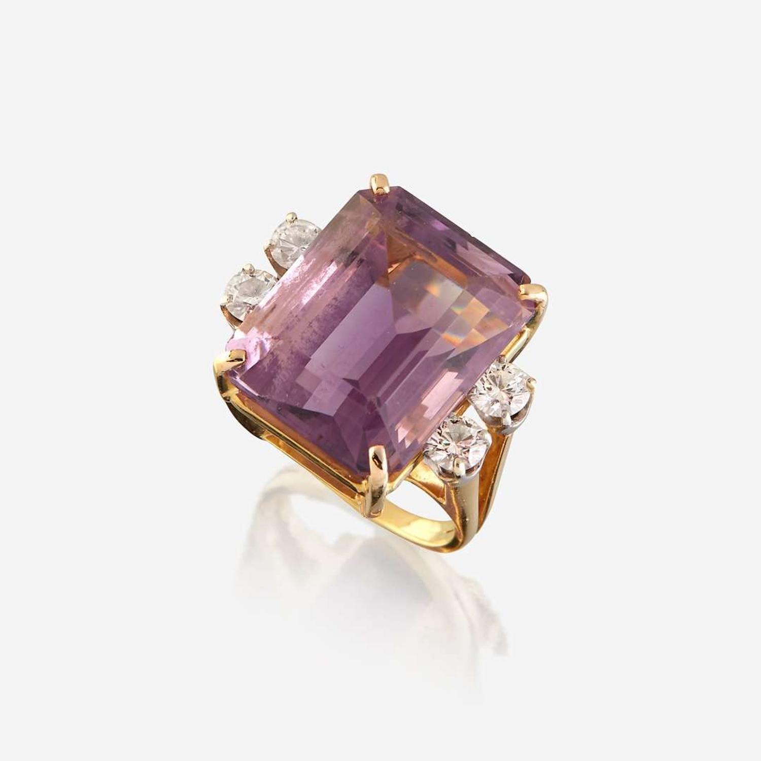 An amethyst, diamond, white stone, and gold ring