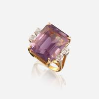 An amethyst, diamond, white stone, and gold ring
