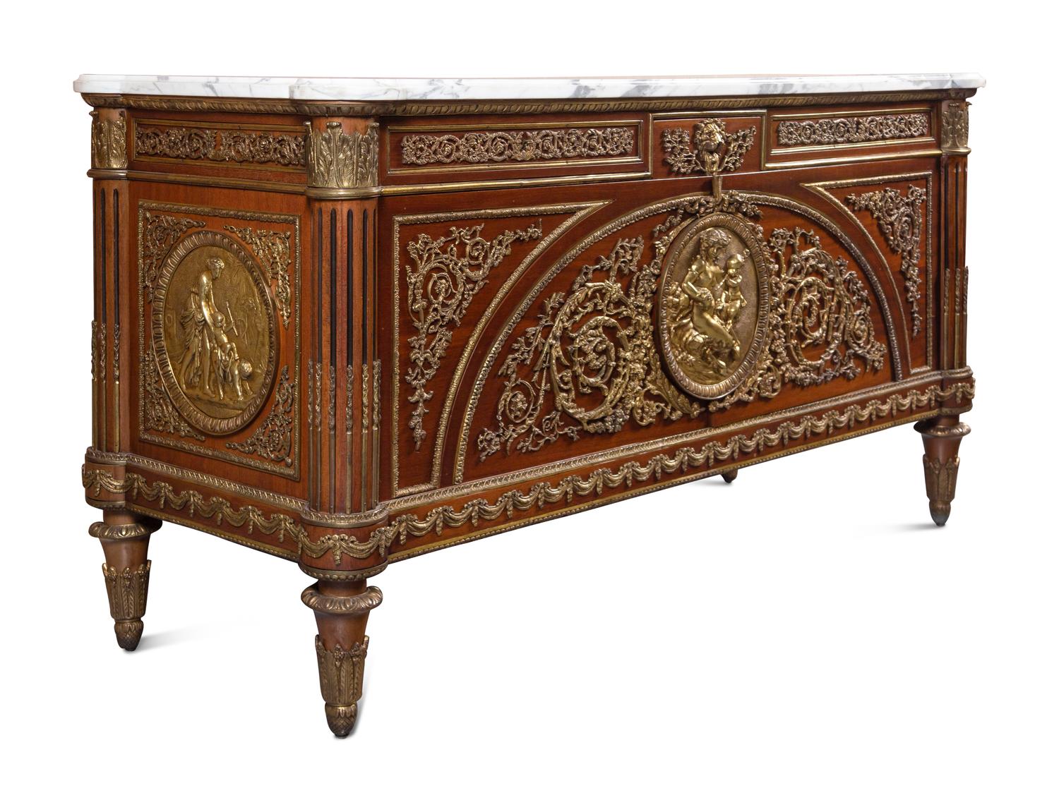 A Louis XVI Style Gilt Bronze Mounted Mahogany Marble-Top Commode à Vantaux, after the Model by Guillaume Benneman