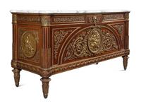 A Louis XVI Style Gilt Bronze Mounted Mahogany Marble-Top Commode à Vantaux, after the Model by Guillaume Benneman