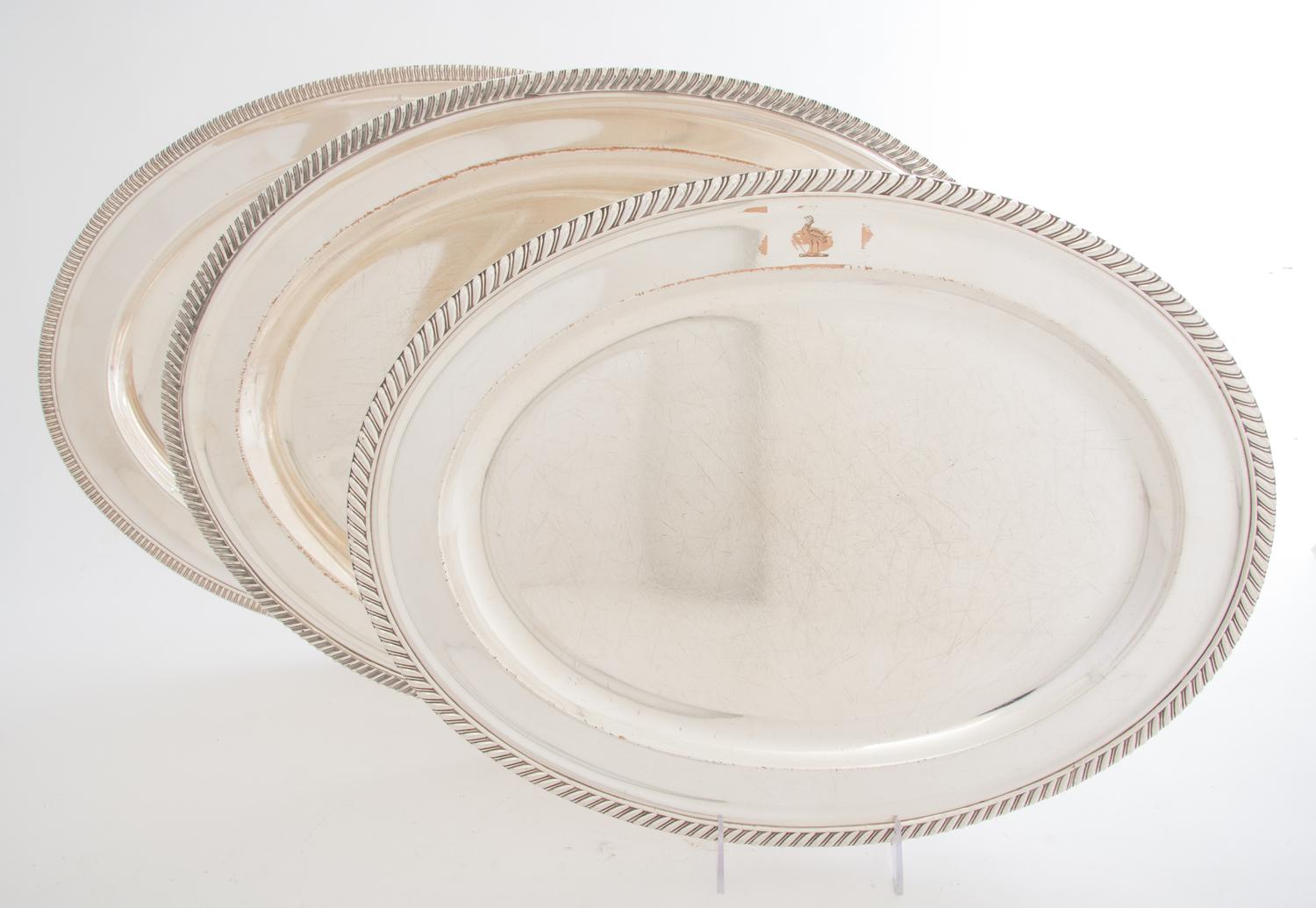 A Collection of Five Silver-plate Trays, , four oval, one rectangular with handles, each with gadrooned edges.
