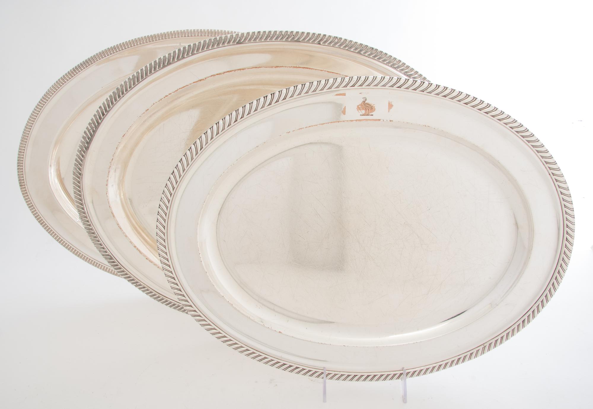A Collection of Five Silver-plate Trays, , four oval, one rectangular with handles, each with gadrooned edges.