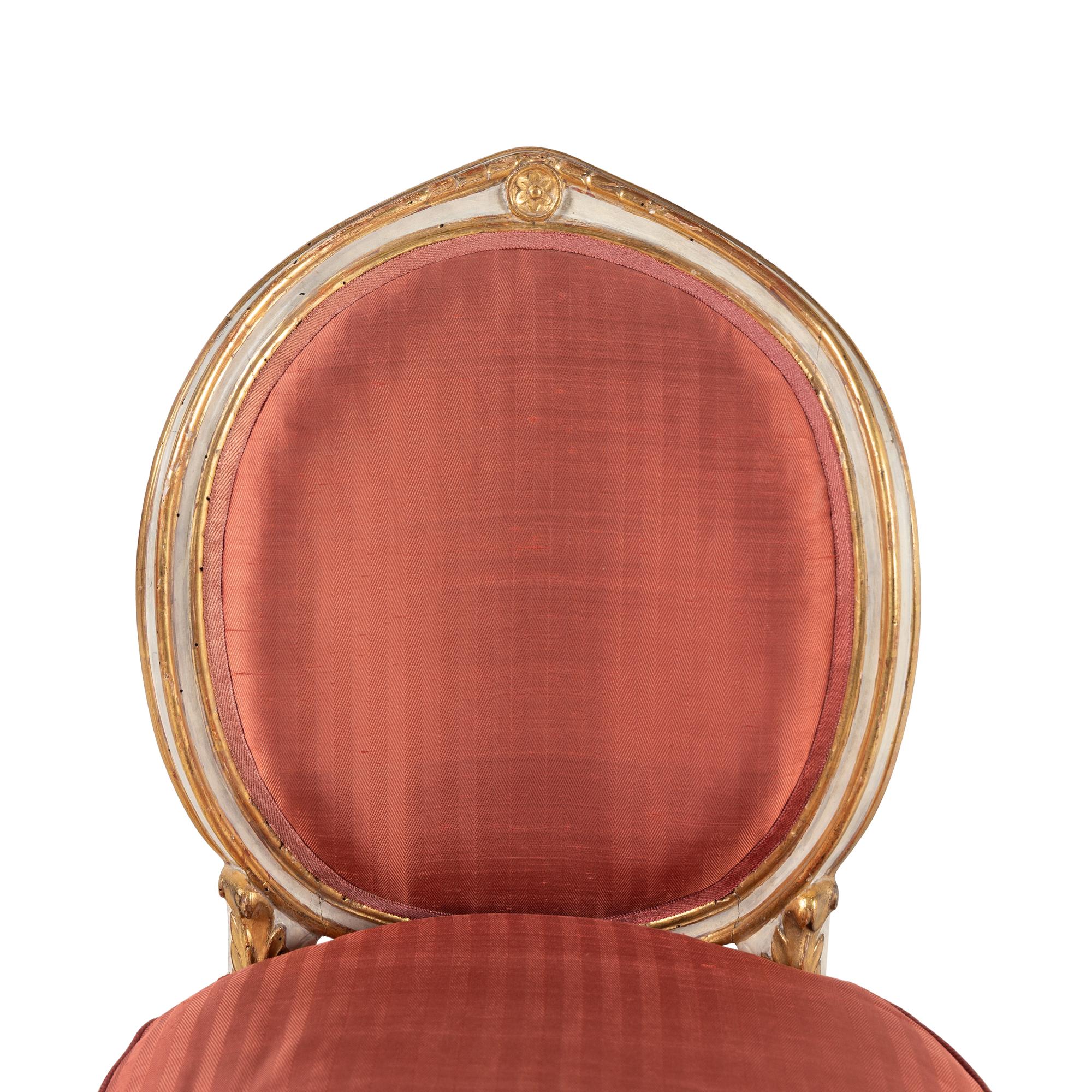 A Set of Four Italian Neoclassical Crème-Painted and Parcel Gilt Side Chairs
