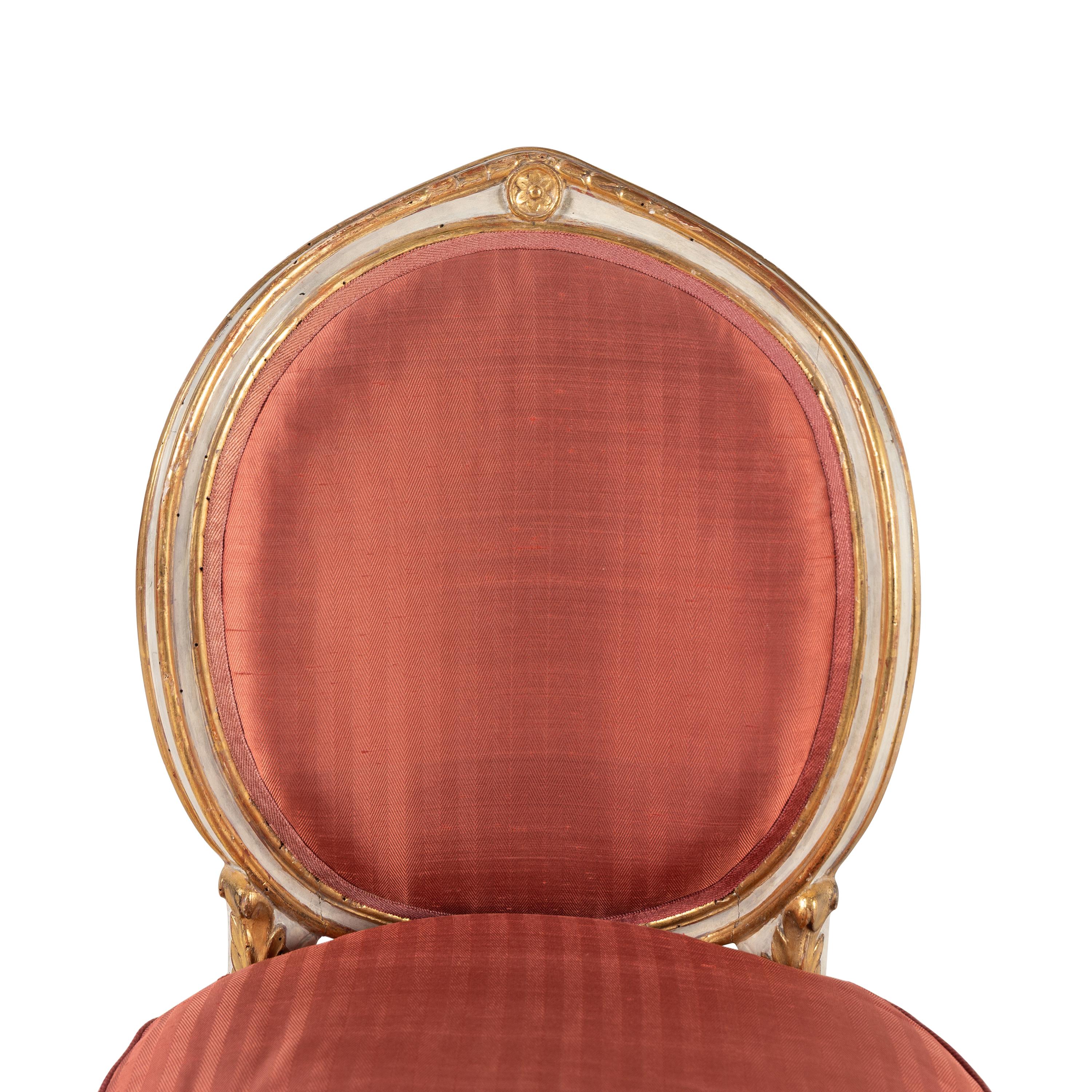 A Set of Four Italian Neoclassical Crème-Painted and Parcel Gilt Side Chairs
