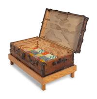 A Goldsmith & Son Never Break Trunk Raised on a Later Stand as a Table