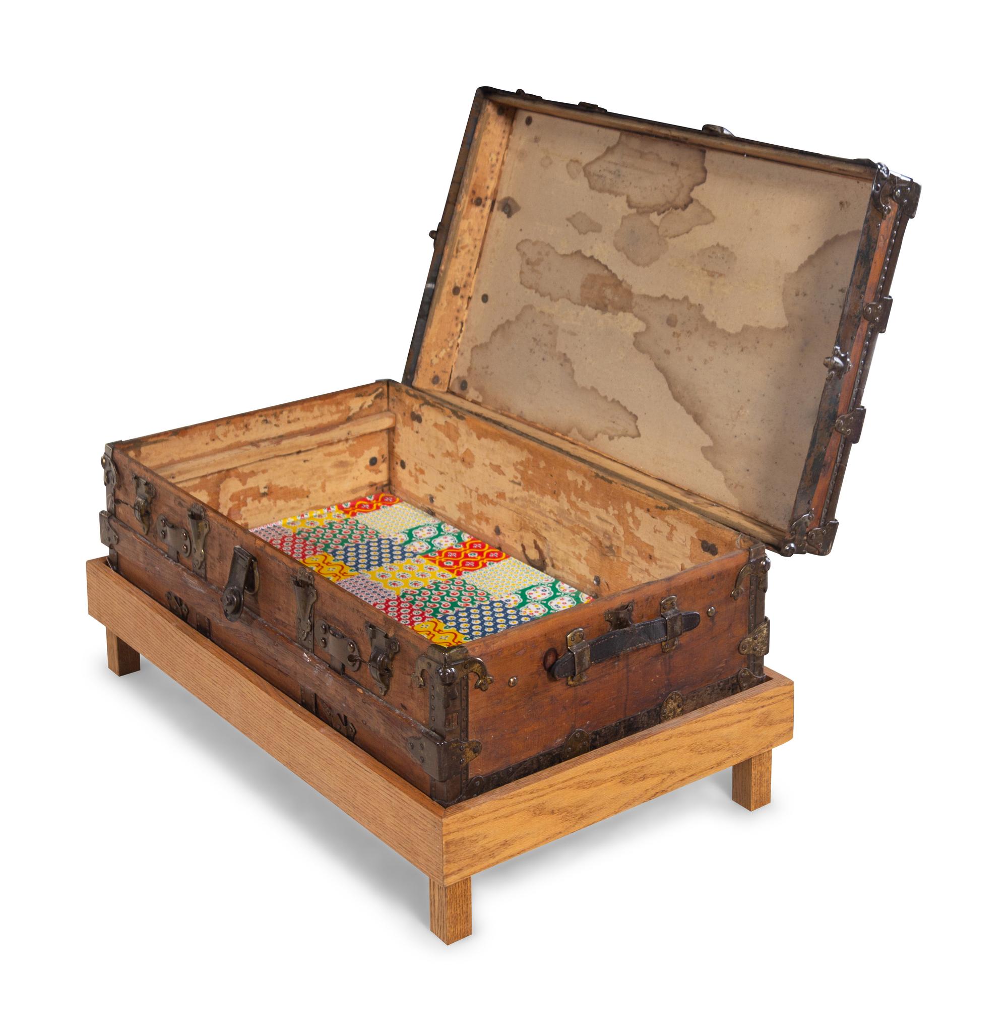 A Goldsmith & Son Never Break Trunk Raised on a Later Stand as a Table