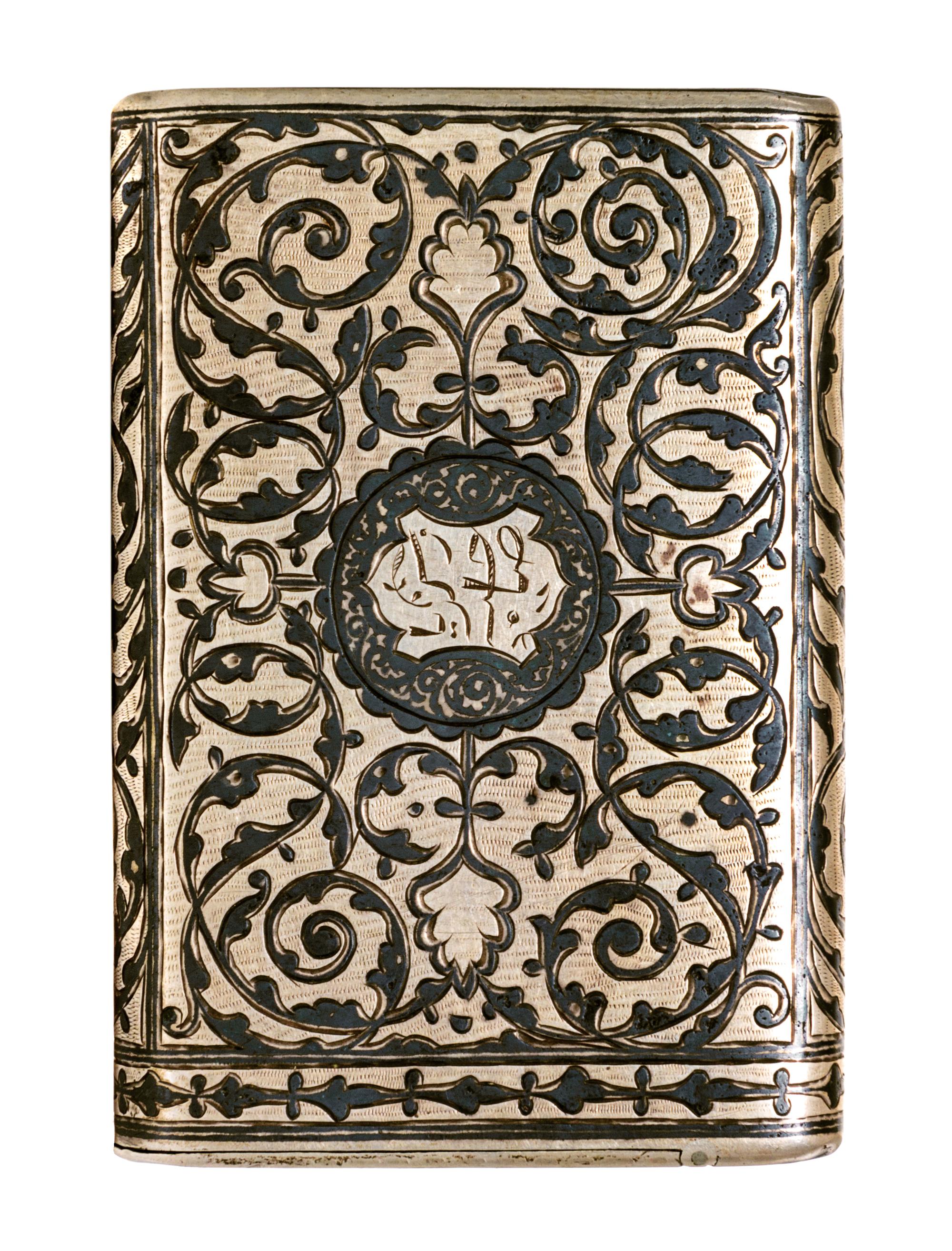 A Russian Niello Silver Cigarette Case, Moicye or Maxim Ivanov, 1896-1908, of rectangular form, the lid centered with Cyrillic script o