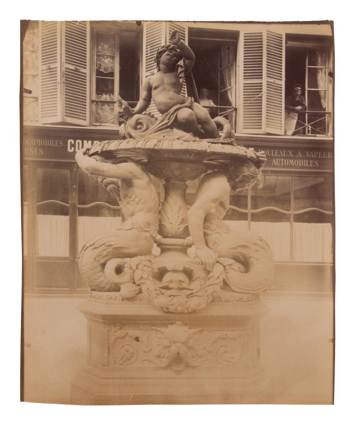 A group of four photographs ( Untitled [man at fountain], circa 1900s; Boutique empire, 14 rue de Grammont , 1903-1904; Hôtel de Neuville, rue Alphonse de Neuville, 1905-1906; Fontaine, faubourg Saint-Martin, 1912)
